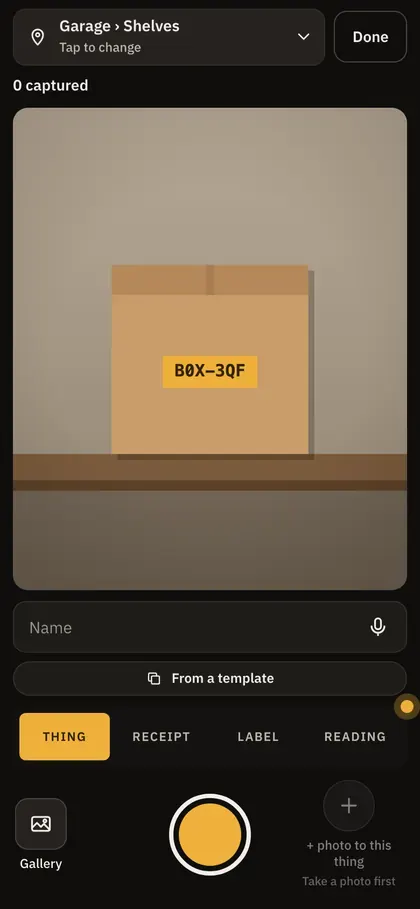 The capture screen on a phone, its camera on a labelled box on the garage shelves